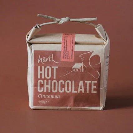 Packaged hot chocolate with a cinnamon flavor on a brown background