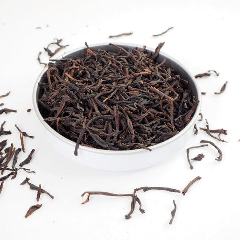 Ceylon Orange Pekoe Loose Tea Leaves - Orange Pekoe is a good quality tea from Srilanka that produces a light amber infusion, great without milk. This shows large rolled tea leaves spilling over. Loose leaf tea from Teaspoon Tea C