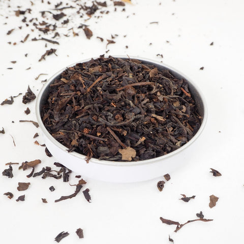 Poppy Oolong Loose Leaf Tea from Teaspoon Tea Co. Large delicate leaves and stalks can be seen in a shallow bowl, Poppy Oolong is a quality tea, a loose leaf tea.