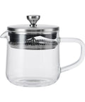 Clear glass teapot with metal lid and handle on a white background