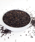A bowl filled with loose leaf Kenya tea, showcasing the tea leaves 