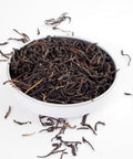 English Breakfast, Loose English Breakfast Tea from online teashop Teaspoon Tea Company, Large Rolled tea leaves produce a high quality tea shown here in a small shallow dish.
