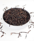 Ceylon Orange Pekoe Loose Tea Leaves - Orange Pekoe is a good quality tea from Srilanka that produces a light amber infusion, great without milk.  This shows large rolled tea leaves spilling over.  Loose leaf tea from Teaspoon Tea C