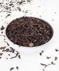 Poppy Oolong Loose Leaf Tea from Teaspoon Tea Co.  Large delicate leaves and stalks can be seen in a shallow bowl, Poppy Oolong is a quality tea, a loose leaf tea.