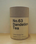 Canister of No.63 Dandelion Tea on a wooden surface with a plain background