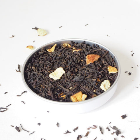 Loose tea leaves of lemon tea scattered on a white background