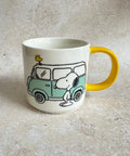 Mug with a design of snoopy dog and a camper van