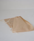 A self fill tea bag with the drawstring pulled