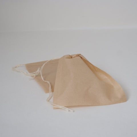 A self fill tea bag with the drawstring pulled