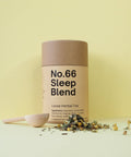 A cylindrical paper container labeled 'No.66 Sleep Blend Loose Herbal Tea' with scattered herbs around it on a yellow background.