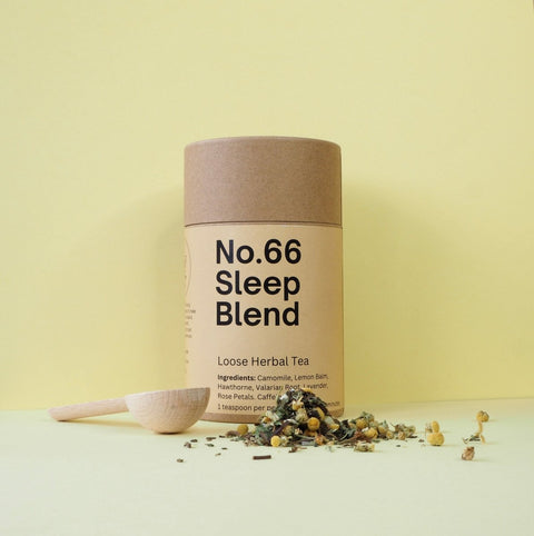 A cylindrical paper container labeled 'No.66 Sleep Blend Loose Herbal Tea' with scattered herbs around it on a yellow background.
