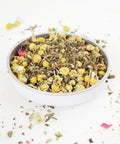 Sleep blend loose tea leaves scattered on a table