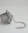 stainless steel infser basket on its side with chain